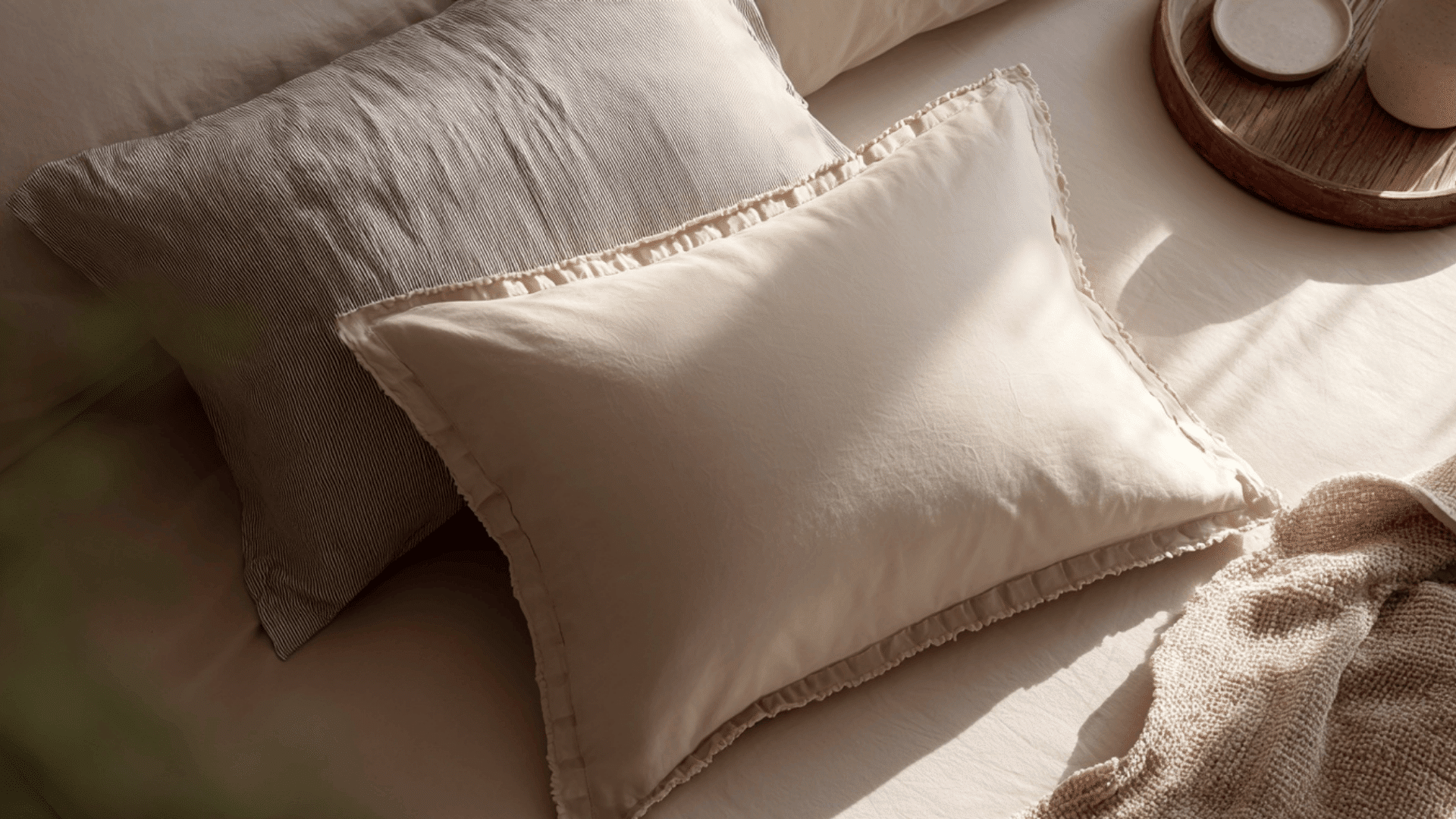 Close-up of pillow sham and pillow case on bed