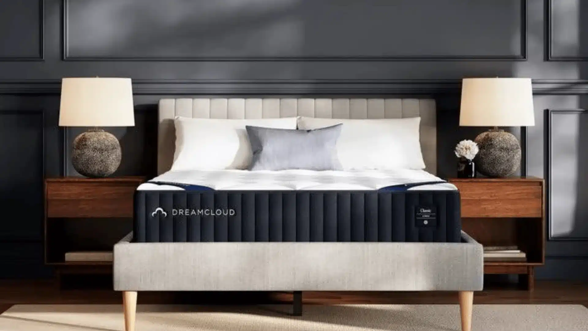 DreamCloud Classic mattress on a modern bed with pillows and bedside lamps