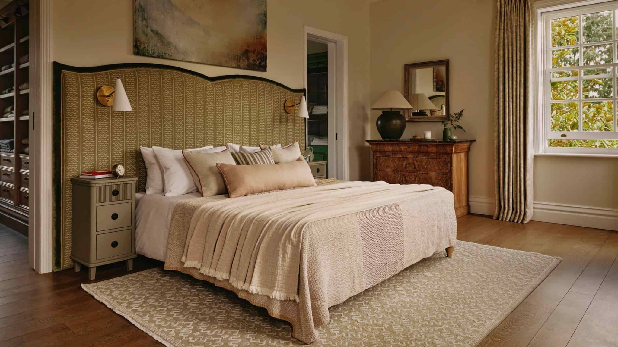 bed with pillows and bedsheet, lamps on the top corners