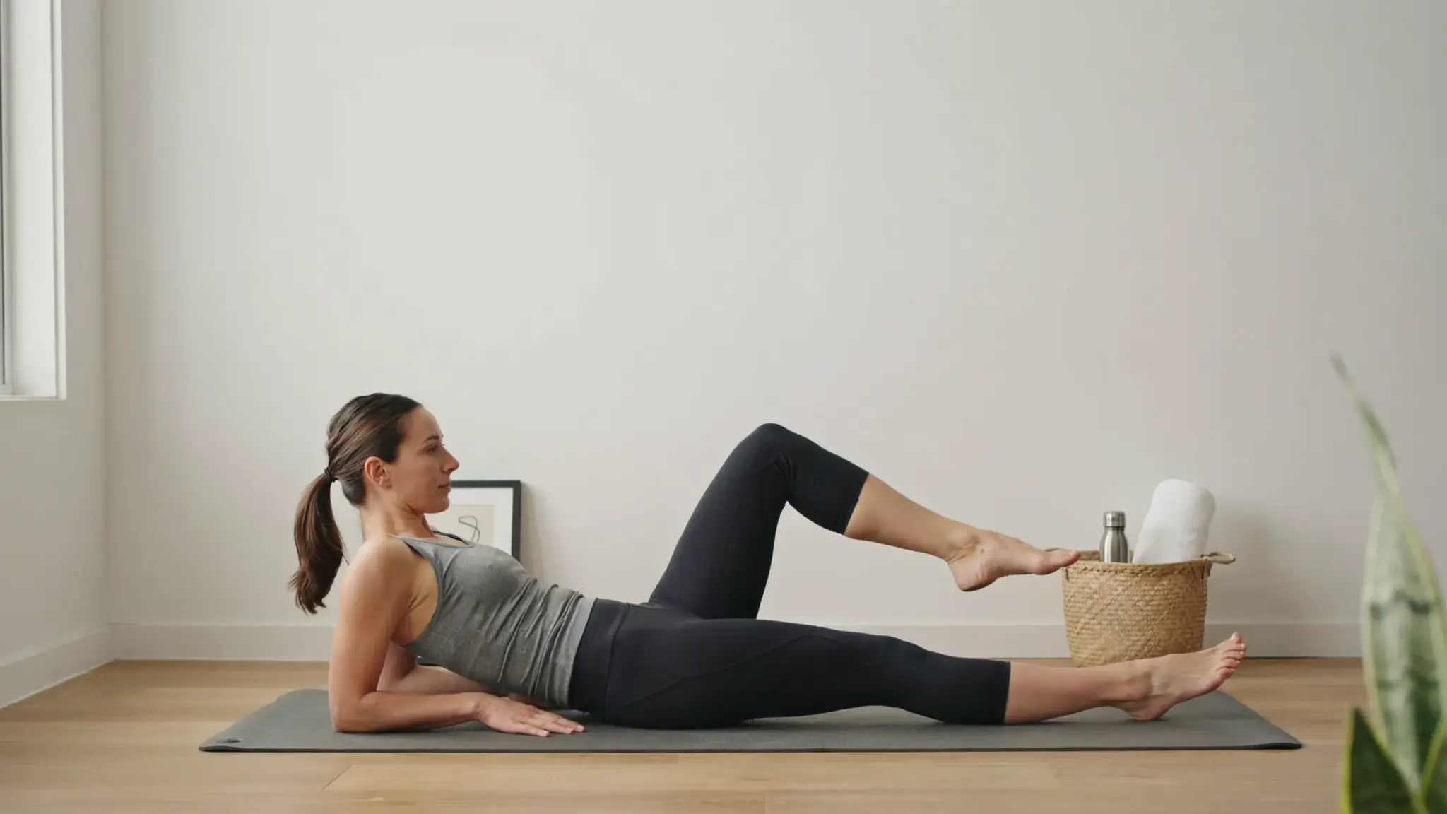 Person performing side leg raises on yoga mat to strengthen hips and reduce IT band strain.