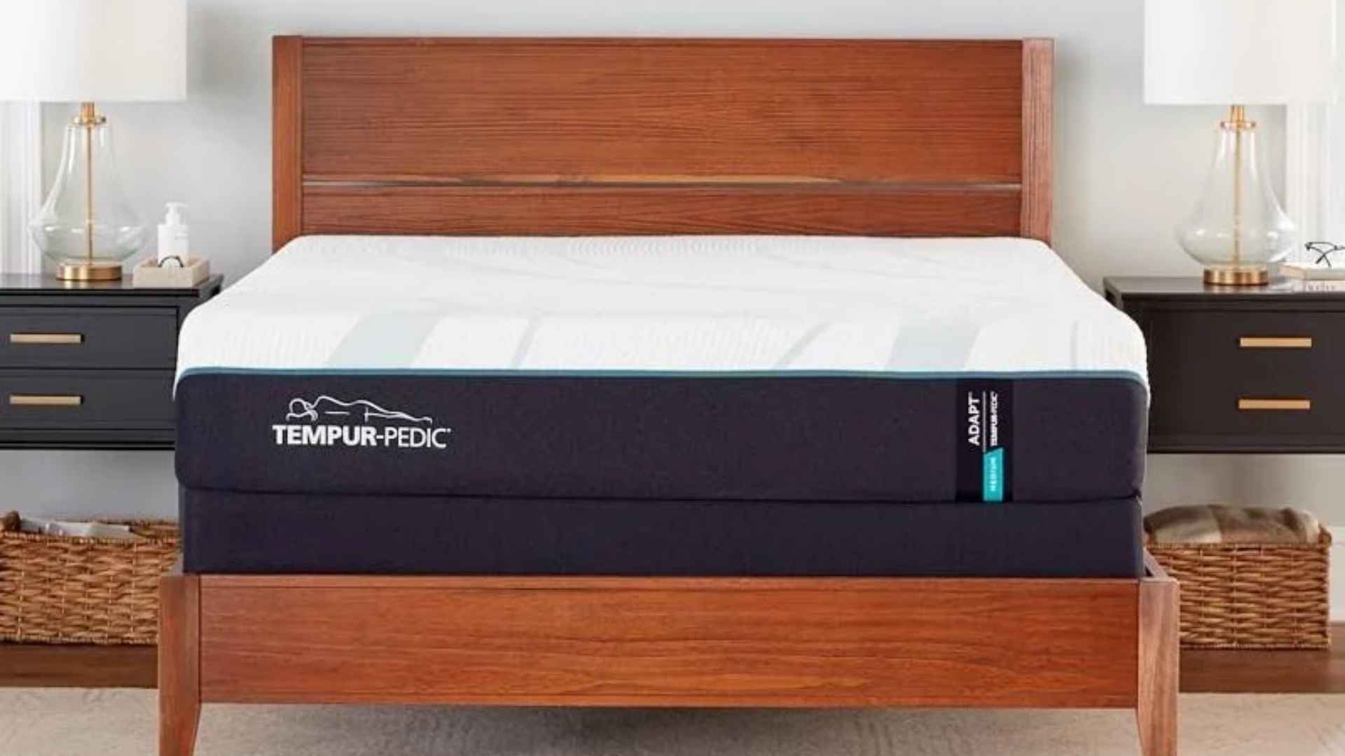 Tempur-Pedic Adapt memory foam mattress on wooden bed frame with modern nightstands and neutral decor.