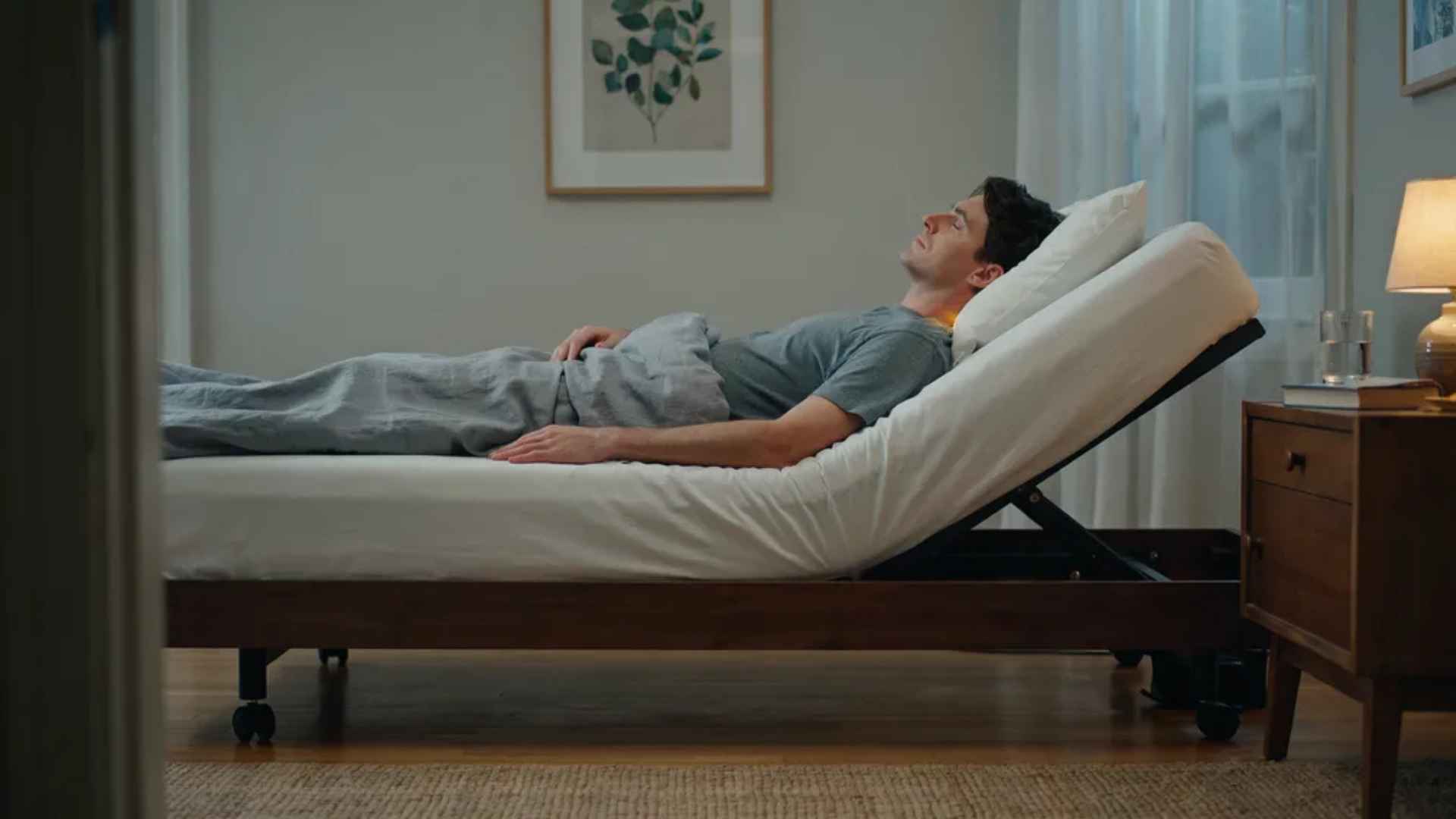 Person sleeping on a bed raised 6 to 8 inches at the head end showing correct full torso incline position