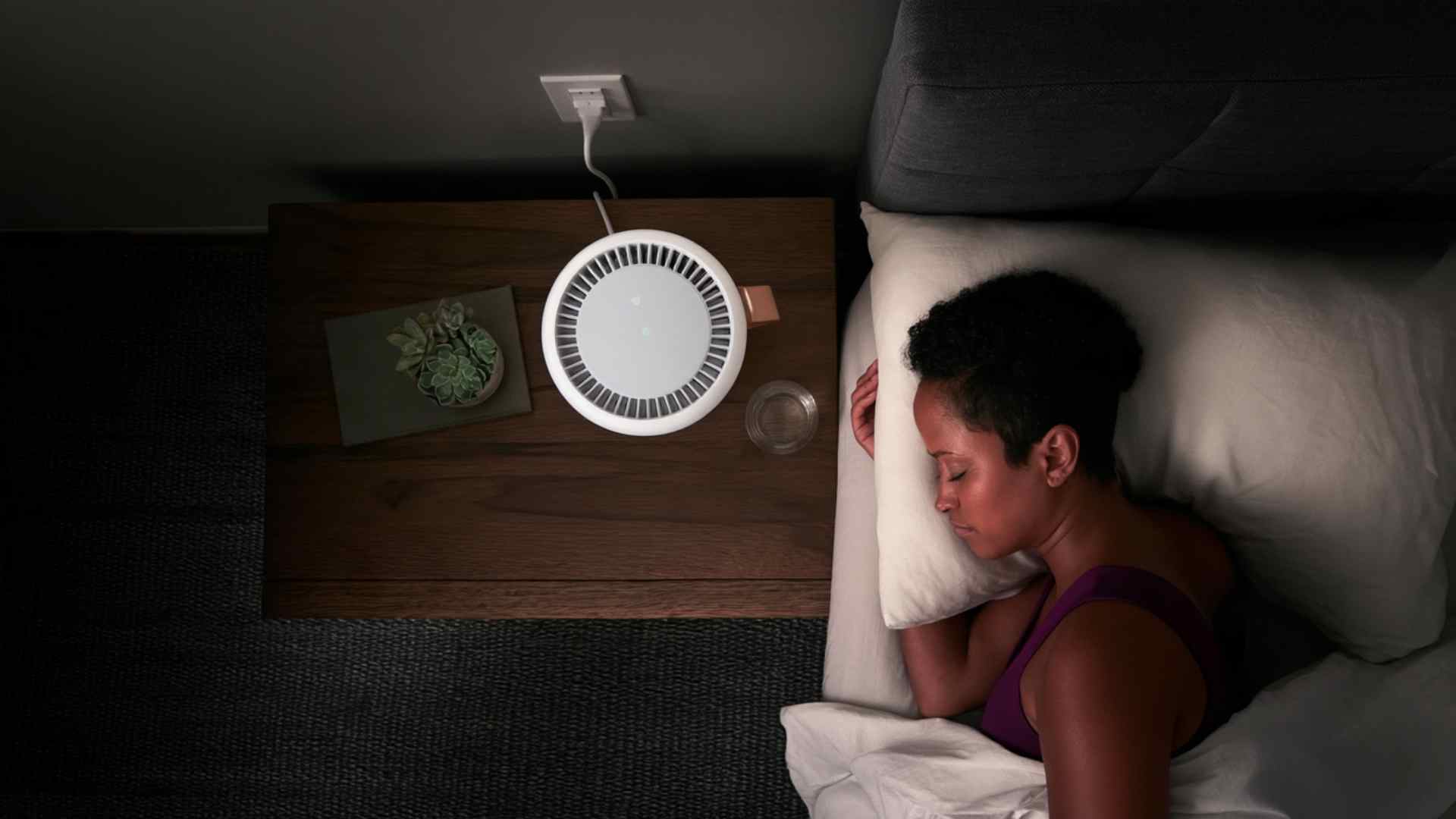 Woman sleeping comfortably in bed while listening to white noise